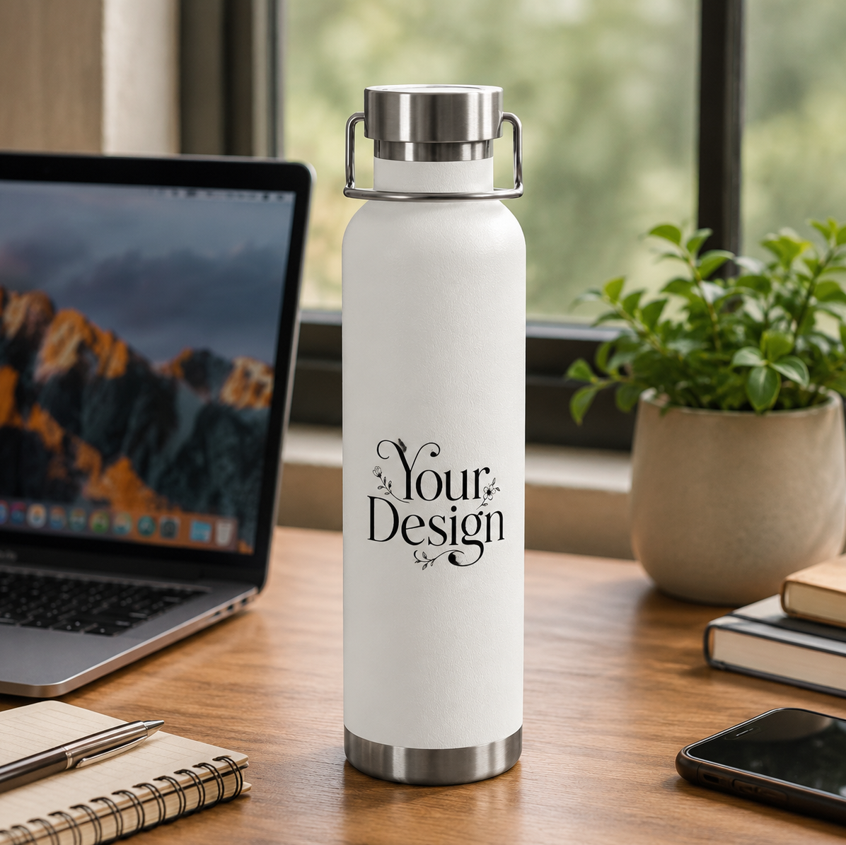 White water bottle with 'Your Design' text on a desk with laptop, notebook, and phone.